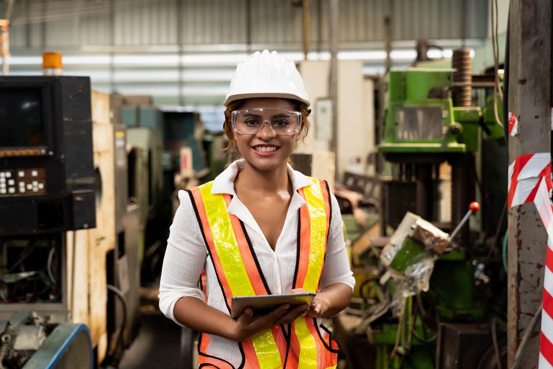 A manufacturing team member uses a tablet on the plant floor
